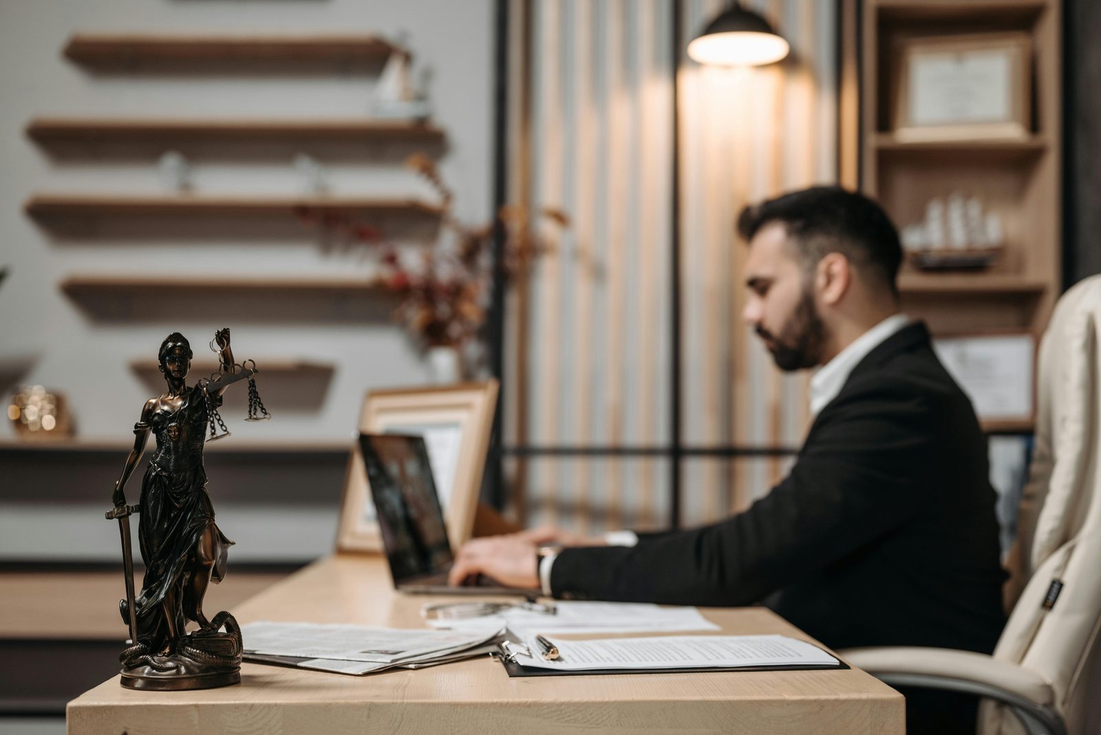 Lawyer working at a desk with the scales of justice